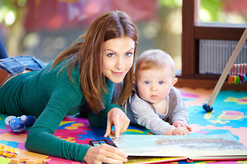 Image showing Portrait, woman and baby with book in home for learning, development or cognitive growth for education. Mother, son or family with reading, bond and lying on floor in living room with toys for future