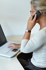 Image showing Mature woman, laptop and work from home, telephone for company, remote working and technology. Office desk, internet and professional for job, web and employee for receptionist, call and typing email
