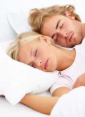 Image showing Love, relax and a couple sleeping in bed in the morning in their home together for holiday or vacation. Face, dream or eyes closed to rest with a young woman and man in the bedroom of their apartment