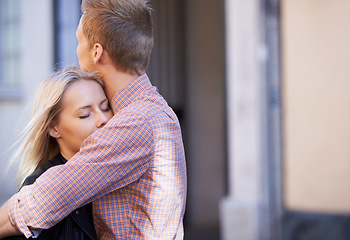 Image showing Love, city and couple hug in street for date, cute relationship and bonding outdoors on weekend. Dating, romance and happy man and woman embrace for flirting, connection and affection in urban town