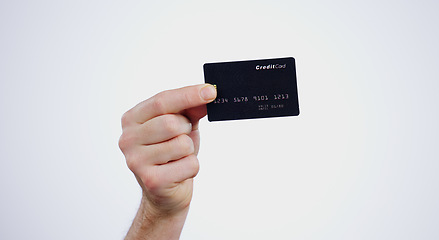 Image showing Hand, payment and closeup of credit card in a studio for online shopping, paying bills or debt. Ecommerce, money and zoom of person with bank account for buying products isolated by white background.