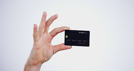 Image showing Hand, money and closeup of credit card in a studio for online shopping, paying bills or debt. Ecommerce, payment and zoom of person with bank account for buying products isolated by white background.