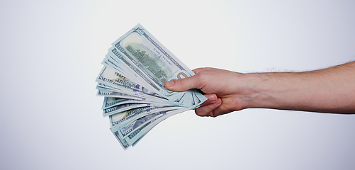 Image showing Hand, payment and closeup of cash in a studio for retail shopping, paying bills or debt. Mockup, paper money and zoom of person with dollar bank notes for buying products isolated by white background