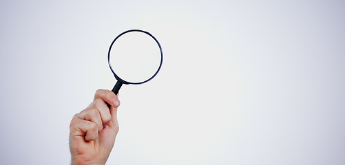 Image showing Magnifying glass searching for deals, hand and investigation, search or study with mockup space on white background. Knowledge, source and spy person with analysis, research and reading with problem
