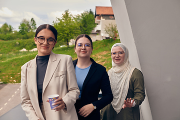 Image showing A group of professional businesswomen taking a break, sipping coffee and engaging in discussions, fostering a sense of empowerment and collaboration in the modern workplace.