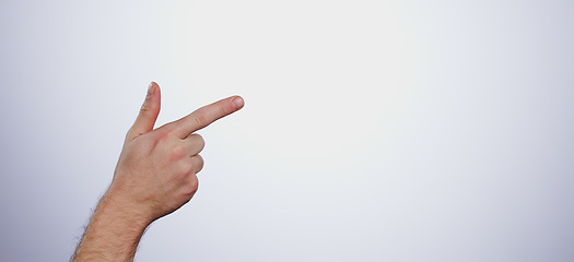 Image showing Hand, pointing and person in studio with mockup space for advertising, promotion or marketing. Finger, closeup and man model with show or presentation gesture for empty mock up by white background.