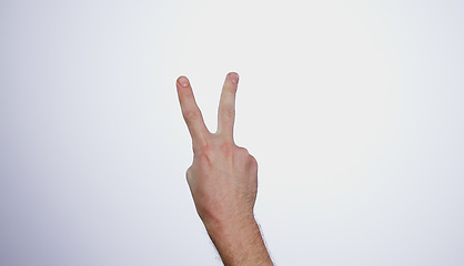 Image showing Hand, counting two and person in studio with mockup space for advertising, peace emoji, promotion or marketing. Fingers, closeup and man model with mathematics numbers gesture for empty mock up by wh