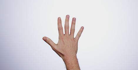 Image showing Hand, counting five and person in studio with mockup space for advertising, promotion or marketing. Fingers stop, hold up closeup and man model with mathematics numbers gesture for empty mock up by w