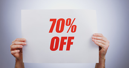 Image showing Discount sign, hands with offer and opportunity for shopping, poster and advertising on white background. Store sale, communication and promotion, person with billboard for 70 off deal for service in