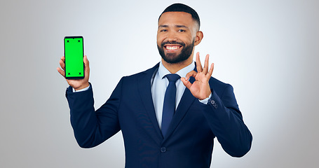 Image showing Phone, green screen portrait of and business man with okay sign in studio for approve, website and social media. Corporate, hand gesture and person on smartphone for mobile app on gray background