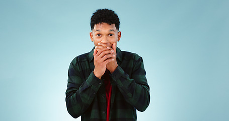 Image showing Surprise, shock and hands on face of man in studio with wow, news or announcement on blue background. Omg, portrait and male model with emoji gesture for unexpected results, feedback or secret gossip