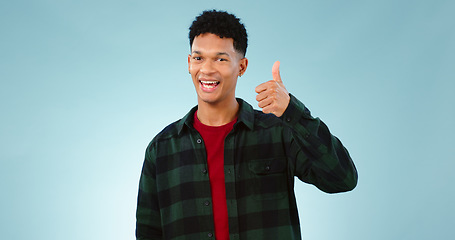 Image showing Thumbs up, happy and portrait of man on blue background for promotion, approval and thank you. Emoji, yes and face of person with hand gesture for agreement, approve and positive feedback in studio