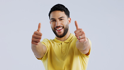 Image showing Thumbs up, portrait and man in studio for winner, achievement and celebrate deal on white background. Happy indian model, emoji and like sign for yes feedback, promotion and thank you for excellence