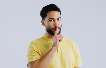 Image showing Secret, man and portrait in studio for sign of privacy, surprise sales and confidential deal on white background. Indian model with finger on lips for quiet, gossip news and mystery emoji to whisper