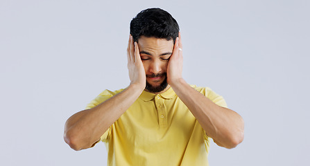 Image showing Stress, anxiety and a young asian man in studio isolated on a white background for mental health. Burnout, headache and the hands of a sad person on his face in frustration for worry or a mistake