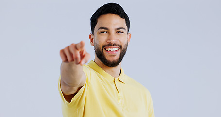 Image showing Man, portrait and pointing to you in studio for choice, decision and vote for winner, volunteer or recruitment on white background. Happy indian model show finger for support, emoji and invitation