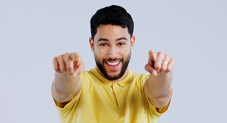 Image showing Happy man, portrait and pointing to you for choice, decision and vote for winner, volunteer or recruitment in studio on white background. Indian model, smile and finger for support, emoji and join us