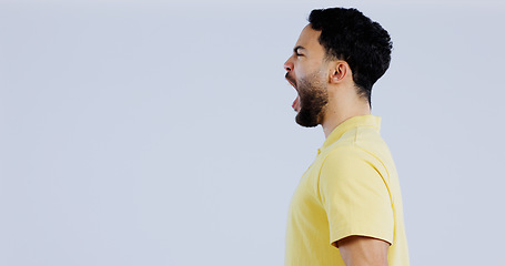 Image showing Scream, angry and man in studio at mockup space for crisis, conflict and mad emoji reaction on white background. Profile of frustrated indian model shouting with stress, anger and negative expression