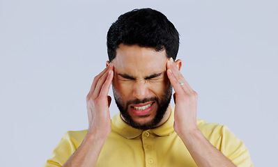 Image showing Headache, sick and man in studio with stress, vertigo and mental health on white background. Face of frustrated indian model with pain, anxiety and tired of migraine, burnout and fatigue of brain fog