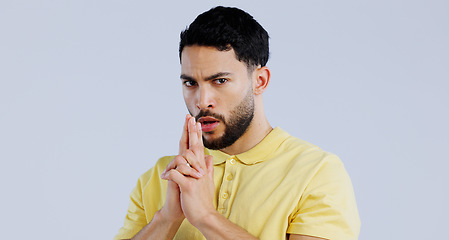 Image showing Finger gun, serious and portrait of man in studio with aim for target, shooting and spy on blue background. Secret agent, security mockup and face of person with hand gesture for pistol or weapon