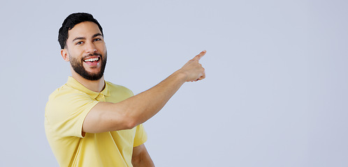 Image showing Happy, man and portrait of pointing to space in studio for advertising information, deal and choice on white background. Indian model, presentation and mockup for feedback, promotion and announcement