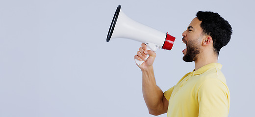 Image showing Man, megaphone and studio profile in space, mockup and shout for rally, promo or announcement by background. Speaker, protest or call to action for justice with speech, sound and anger with bullhorn