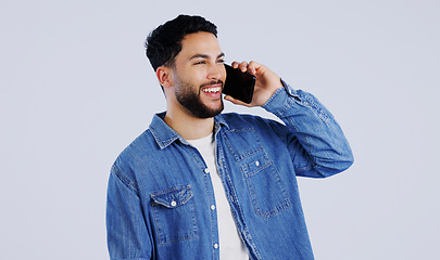 Image showing Man, phone call and communication in studio for contact, networking and funny conversation on white background. Happy young indian model, mobile discussion and laugh for chat, talking and connection