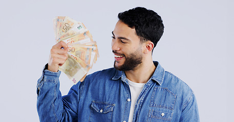 Image showing Man, money fan and smile in studio with thinking for financial freedom, goals and decision with success by background. Person, ideas and winner with bonus cash, revenue or excited for salary increase