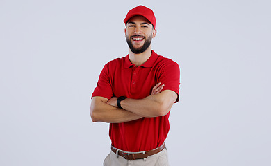 Image showing Happy man, portrait and professional delivery guy with arms crossed in confidence against a gray studio background. Male person, model or courier worker smile with red hat for service on mockup space