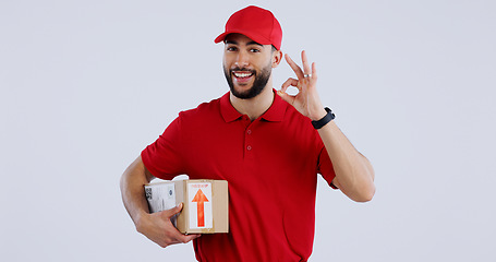 Image showing Portrait, man and box with okay sign on studio for delivery, logistics and mockup for package on white background. Male model, worker or courier with gesture in Mexico for good, choice or decision