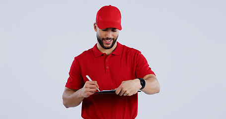 Image showing Happy man, delivery and writing on clipboard for signature, order or form against a studio background. Male person or guy in courier service smile for filling paperwork, legal document or agreement