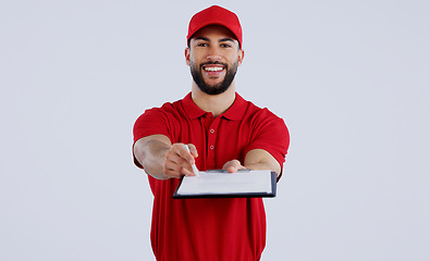 Image showing Courier man, clipboard and studio portrait with giving pen for signature, delivery and happy for shipping. Logistics expert, smile and cardboard package for commercial job with document by background