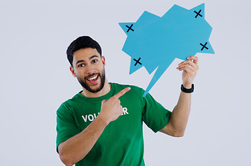 Image showing Portrait, man and volunteer with speech bubble, pointing and promotion on a white studio background. Face, person and charity worker with poster board, tracking markers and options with communication