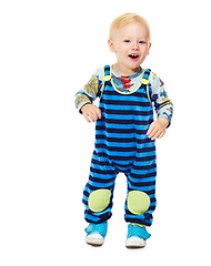 Image showing Baby, boy and toddler in studio with fashion, style and grow with curiosity, happiness and excited for kindergarten. Child, smile and standing in white background in jumpsuit, outfit and clothes
