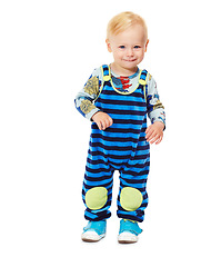 Image showing Toddler, boy and baby in studio with fashion, style and grow with curiosity, happiness and shy for kindergarten. Child, smile and standing in white background in jumpsuit, outfit and clothes