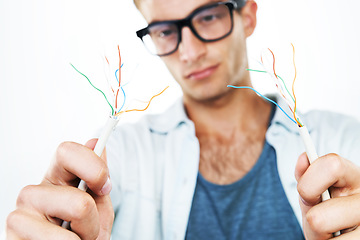 Image showing Working, electrician and man with cables, test and and check for power in white background. Studio, technician or electricity, wires and maintenance of connection, technology or hardware closeup