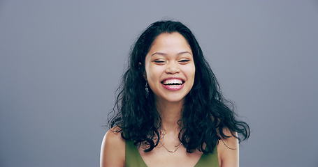 Image showing Face, happy or woman in studio laughing at joke or crazy comedy isolated on gray background. Funny, excited model or silly female person with freedom, goofy smile or joy to relax alone with humor