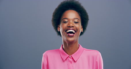 Image showing Woman, funny and laughing for joke, happy and studio by gray background. Black female person, portrait and comedy or silly, goofy and freedom in mockup, humor and smile for positive mindset or crazy
