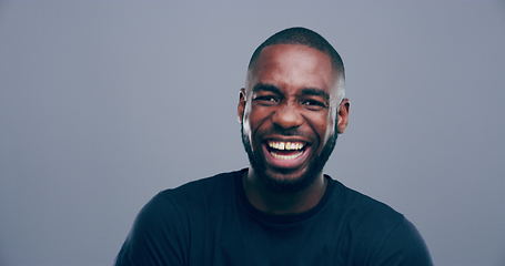Image showing Face, happy or black man laughing at joke or crazy comedy in studio isolated on gray background. Funny, African model or silly male person with freedom, goofy smile or joy to relax alone with humor