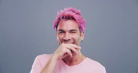 Image showing Face, crazy or happy man in studio laughing at joke or comedy alone isolated on gray background. Cool guy, proud model or silly male person with a funny smile, joy or pink hair to relax with humor