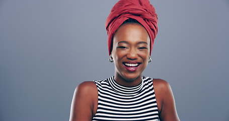 Image showing Face, comedy or happy black woman laughing at joke or crazy humor isolated on gray background. African girl model, funny lady or silly female person with pride, smile or goofy joy to relax in studio