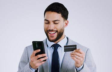Image showing Business man, credit card and phone for online shopping, e commerce or digital payment in studio. Professional worker typing on his mobile for internet banking or debit isolated on a white background