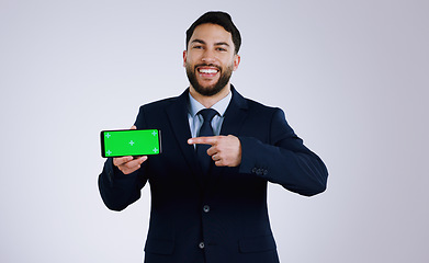 Image showing Professional man, phone green screen and presentation for website, corporate software or job registration in studio. Portrait of business worker pointing to mobile app or mockup on a white background