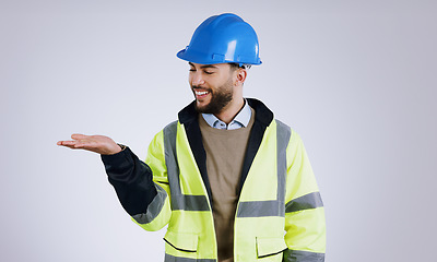 Image showing Happy man, architect and palm for advertising or marketing against a gray studio background. Male person, contractor or engineer smile with hard hat and hand out for deal or service in construction