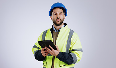 Image showing Man, architect and thinking with tablet for construction or planning against a gray studio background. Male person, contractor or engineer in wonder, thought or plan with technology for architecture