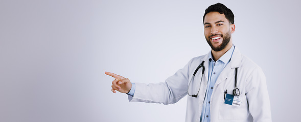 Image showing Portrait, smile and doctor pointing at presentation, mockup or space on a white background. Face, happy medical professional advertising and announcement of info, healthcare man and marketing gesture