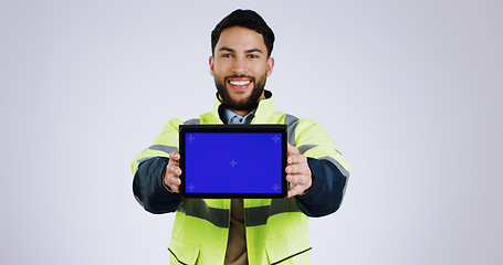 Image showing Engineering man, tablet green screen and presentation for renovation, architecture and design software in studio. Portrait of construction worker with digital technology mockup on a white background