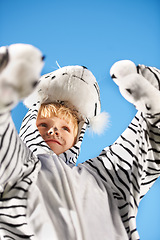 Image showing My costume is the best. Little kid wearing a tiger costumer with his arms raised.