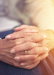 Image showing Hands, retirement and closeup with a mature woman indoor thinking about a past memory of nostalgia. Fingers, wrinkles and old age with a senior female pensioner sitting in her home feeling lonely