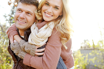 Image showing Enjoying the perfect outdoors date. A happy man piggybacking his girlfriend while spending time in the woods.